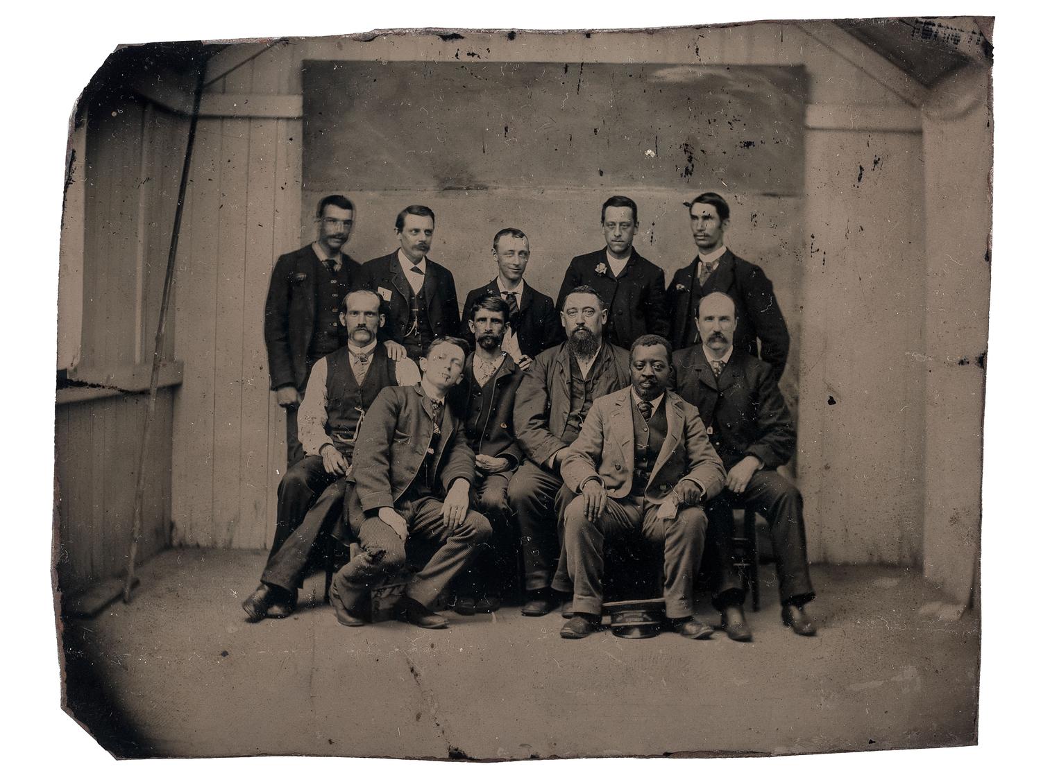[EARLY PHOTOGRAPHY]. A group of 12 occupational photographs highlighted by a tintype of railroad workers including an African American subject.