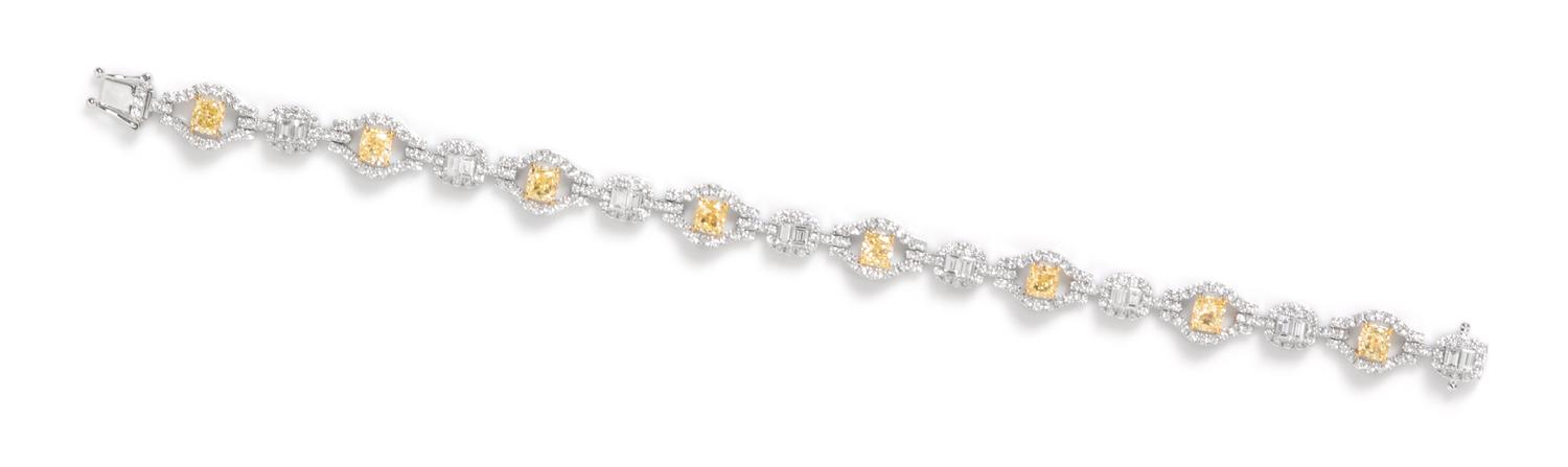 An 18 Karat White Gold, Colored Diamond and Diamond Bracelet, 11.90 dwts.
