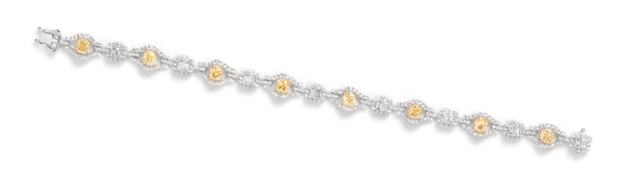 An 18 Karat White Gold, Colored Diamond and Diamond Bracelet, 11.90 dwts.