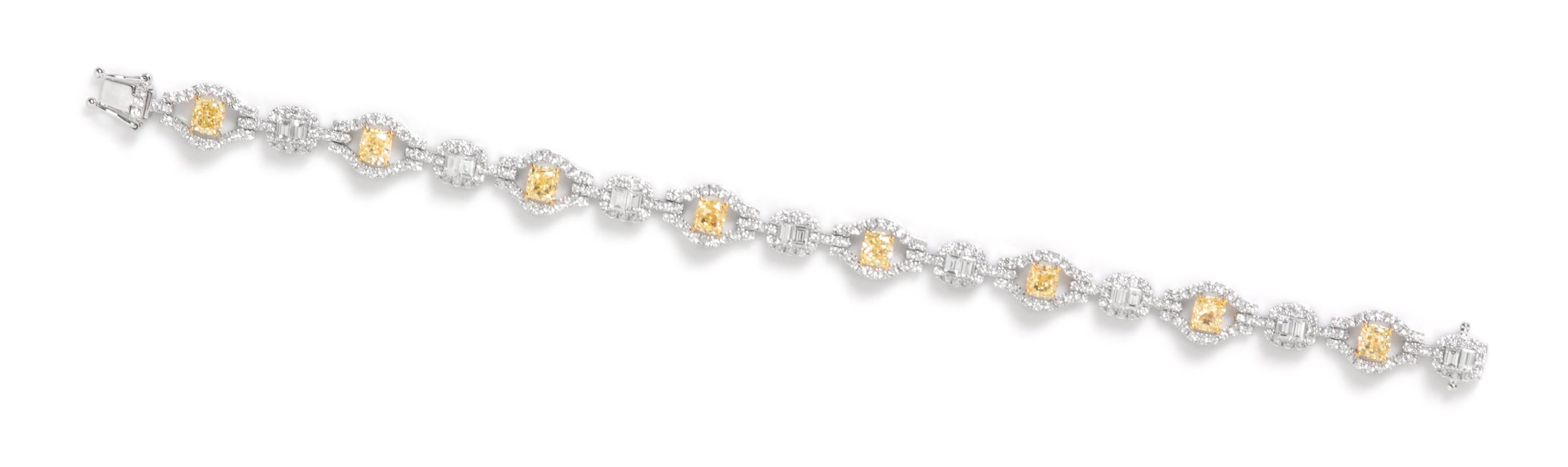 An 18 Karat White Gold, Colored Diamond and Diamond Bracelet, 11.90 dwts.