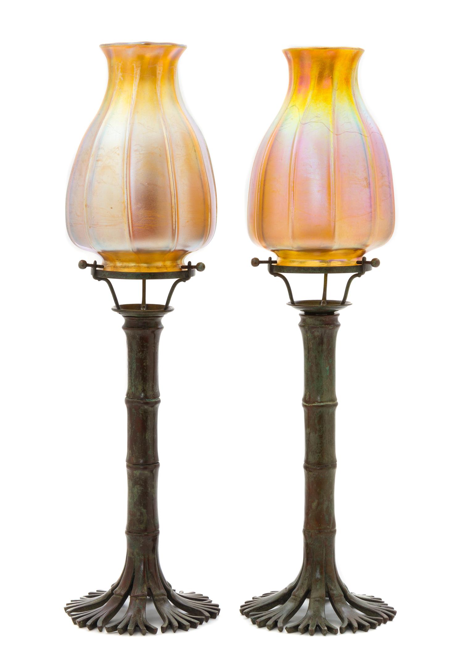 A Pair of Tiffany Studios Favrile Glass and Bronze Bamboo Candlesticks Height of shades 6 3/4 inches, height overall 18 1/4 inches.