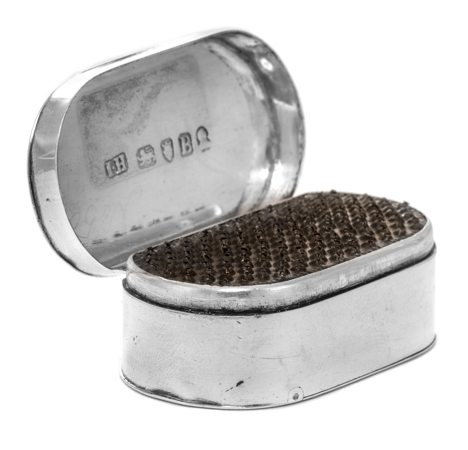A George III Silver Nutmeg Grater, Maker's Mark I.H., London, 1796, of oval form, the hinged lid opening to a grater with a hinged base