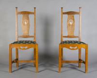 A Pair of Arts and Crafts Oak Side Chairs, After Charles Francis Annesley Voysey, Height 41 3/4 inches.