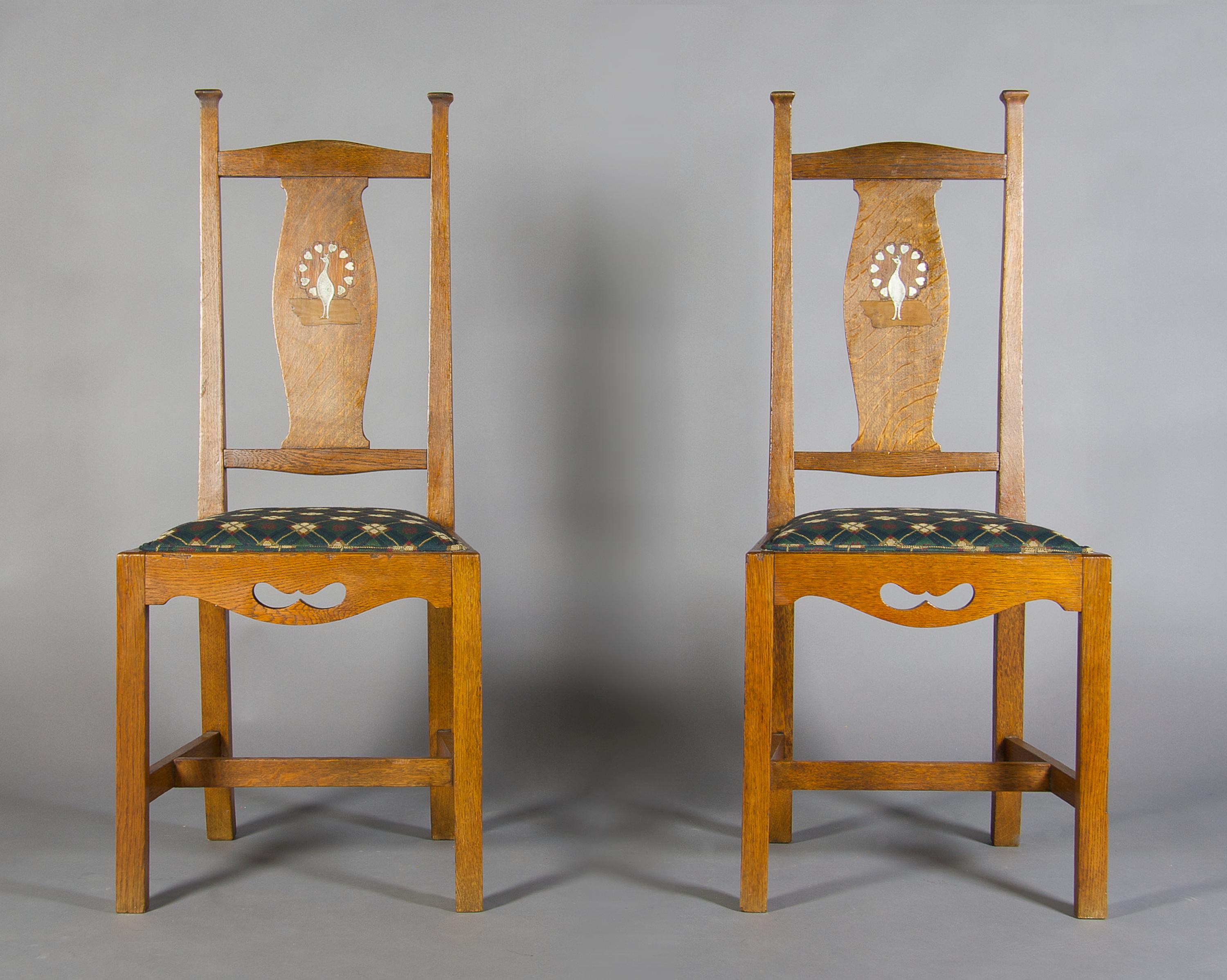A Pair of Arts and Crafts Oak Side Chairs, After Charles Francis Annesley Voysey, Height 41 3/4 inches.