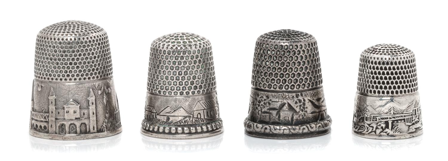 Four American Silver 'Scenic' Thimbles, Various Makers, each having a knurled top and body above a band worked to show village scenes,
