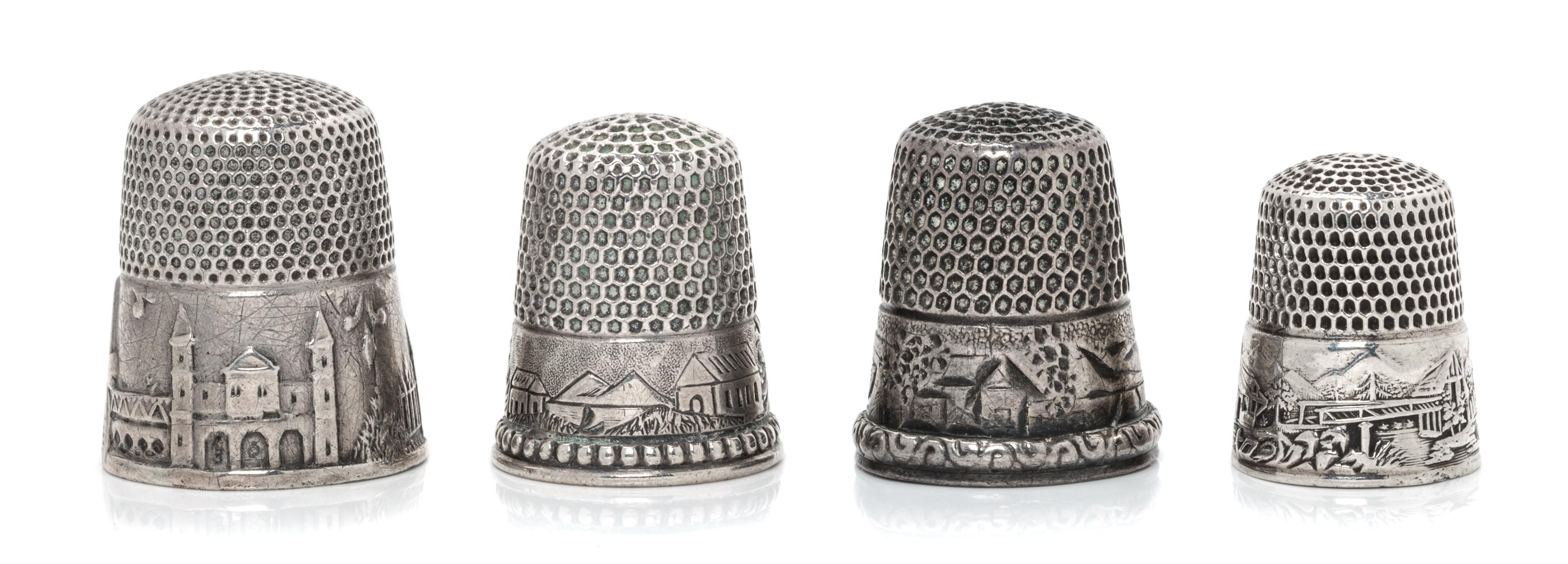Four American Silver 'Scenic' Thimbles, Various Makers, each having a knurled top and body above a band worked to show village scenes,