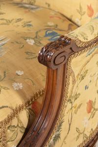 A Pair of Louis XVI Style Carved Walnut Bergères