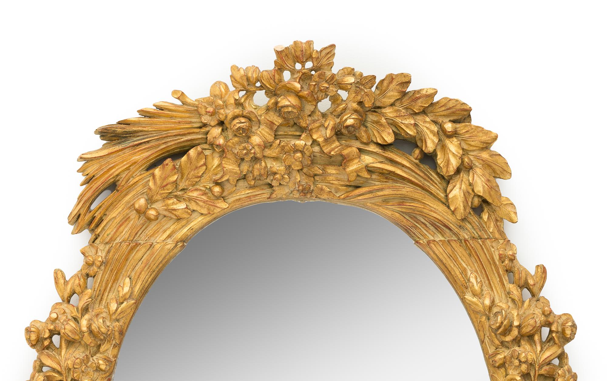 A Large Continental Giltwood Oval Mirror