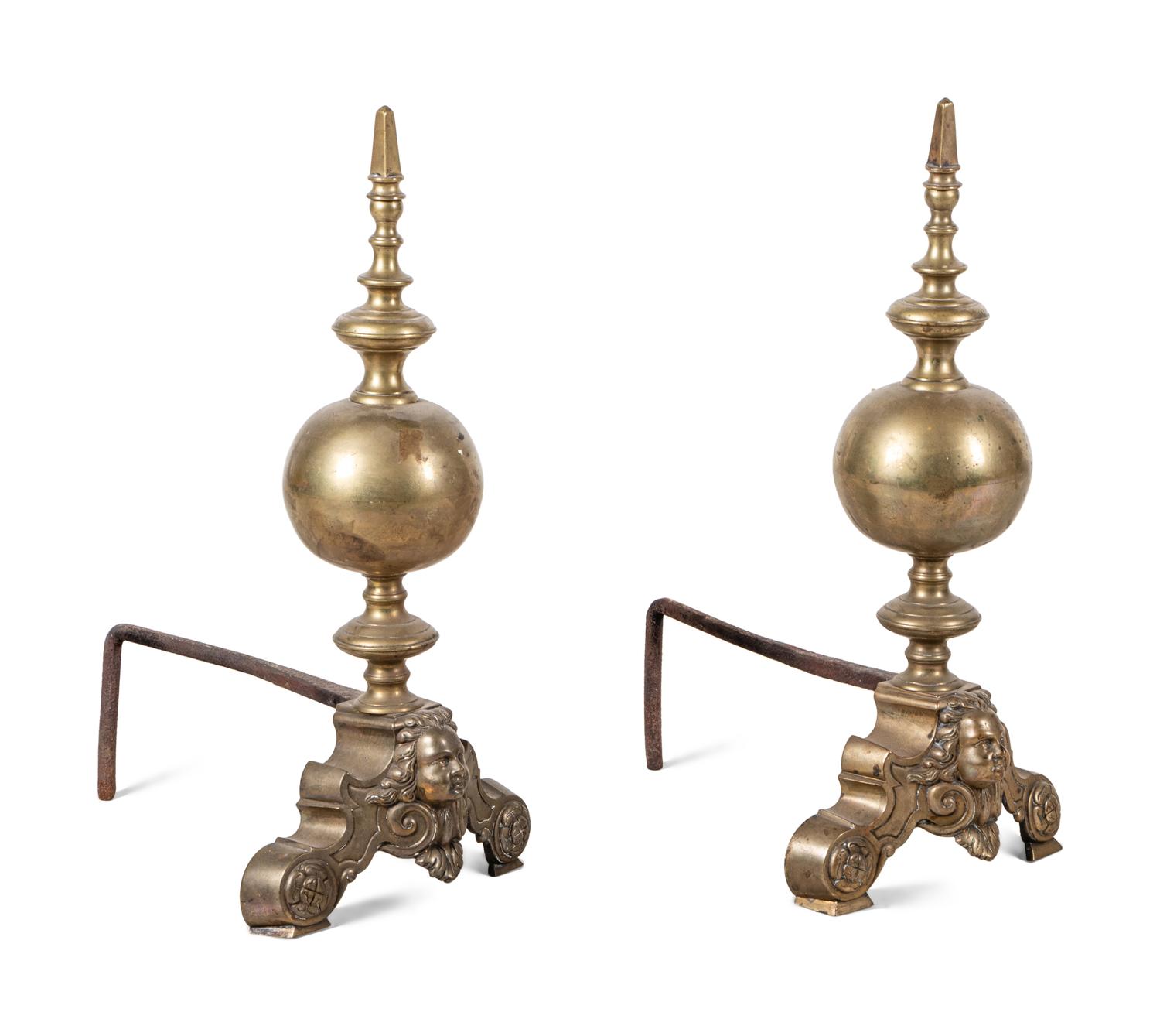 A Pair of Continental Brass Andirons with Masks