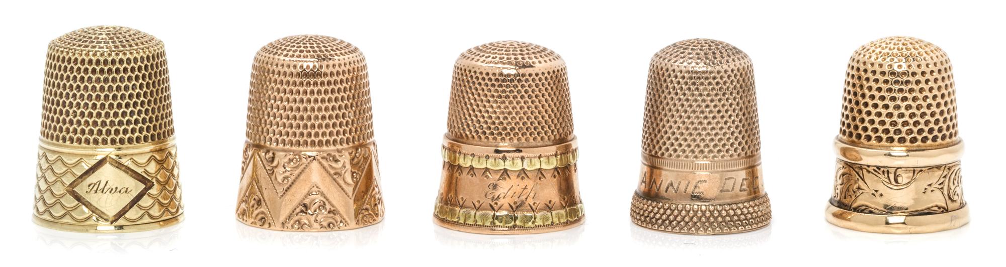 Five American Gold Thimbles, Various Makers, comprising an example with a bi-color gold band to the base, Stern Bros., New York, NY; an