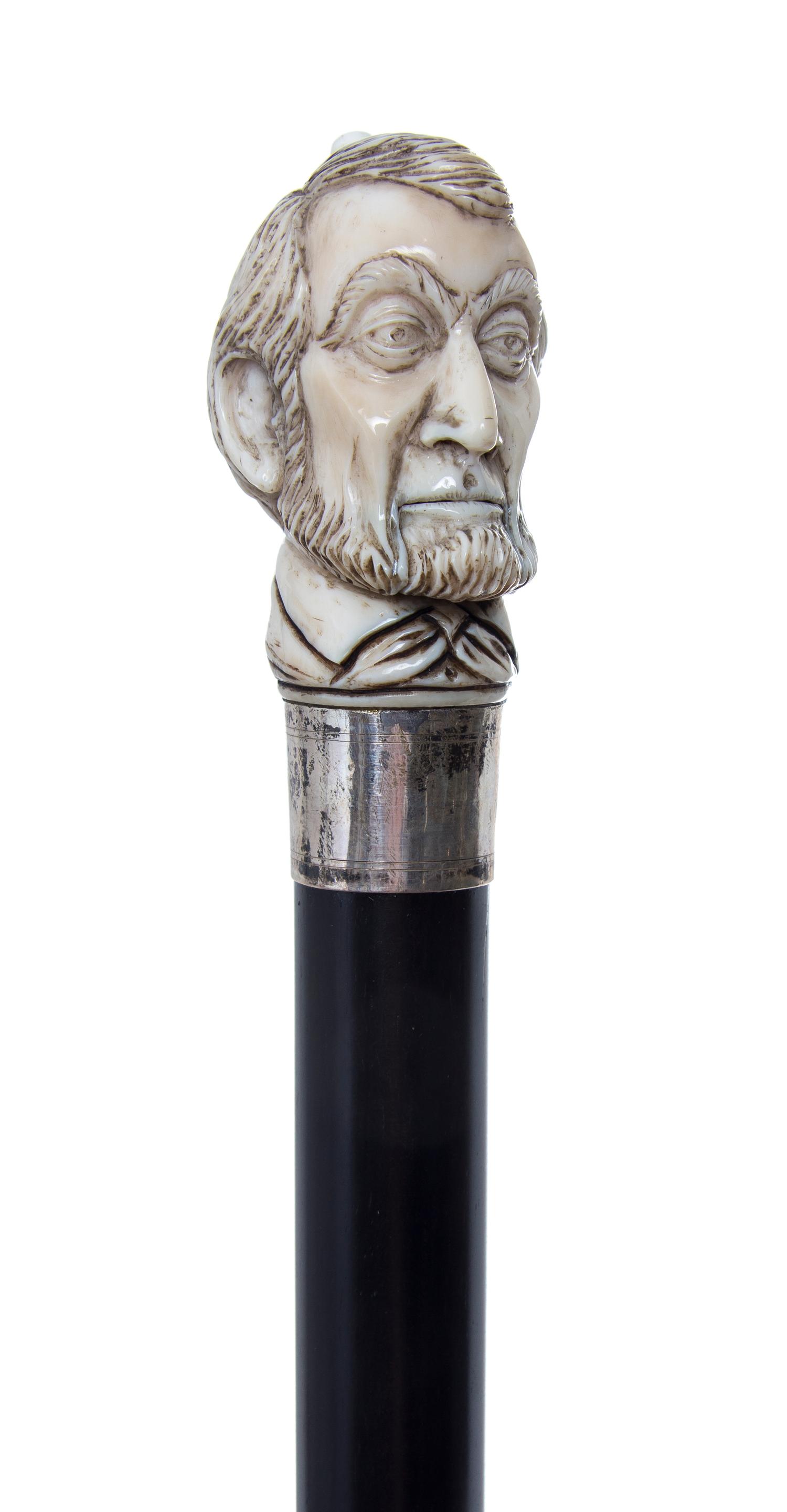 An American Ivory Automaton Handled Cane, Length of handle 2 5/8 x length overall 36 1/8 inches.