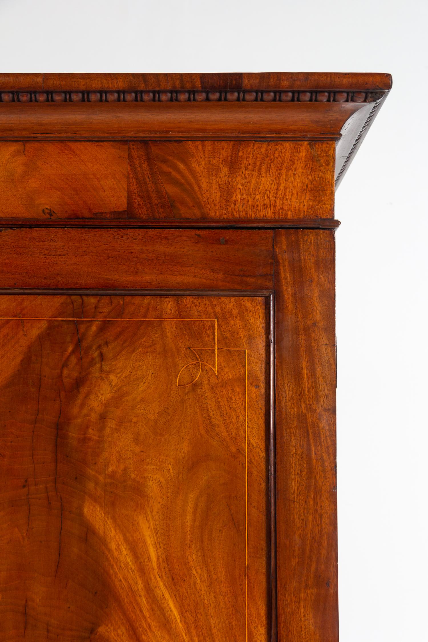 A Regency Mahogany Armoire Simulating a Linen Press