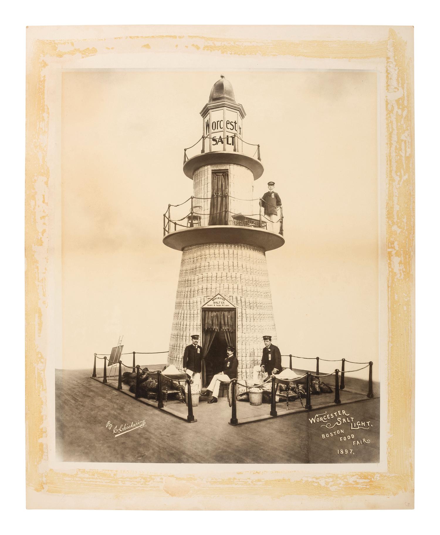 Advertising CHICKERING, Elmer (1857-1915), photographer. Advertisement photograph featuring the Worcester Salt Co. lighthouse display at the Boston Food Fair. Boston, MA: 1897.
