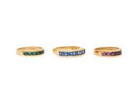 COLLECTION OF THREE RUBY, EMERALD, SAPPHIRE, AND YELLOW GOLD RINGS