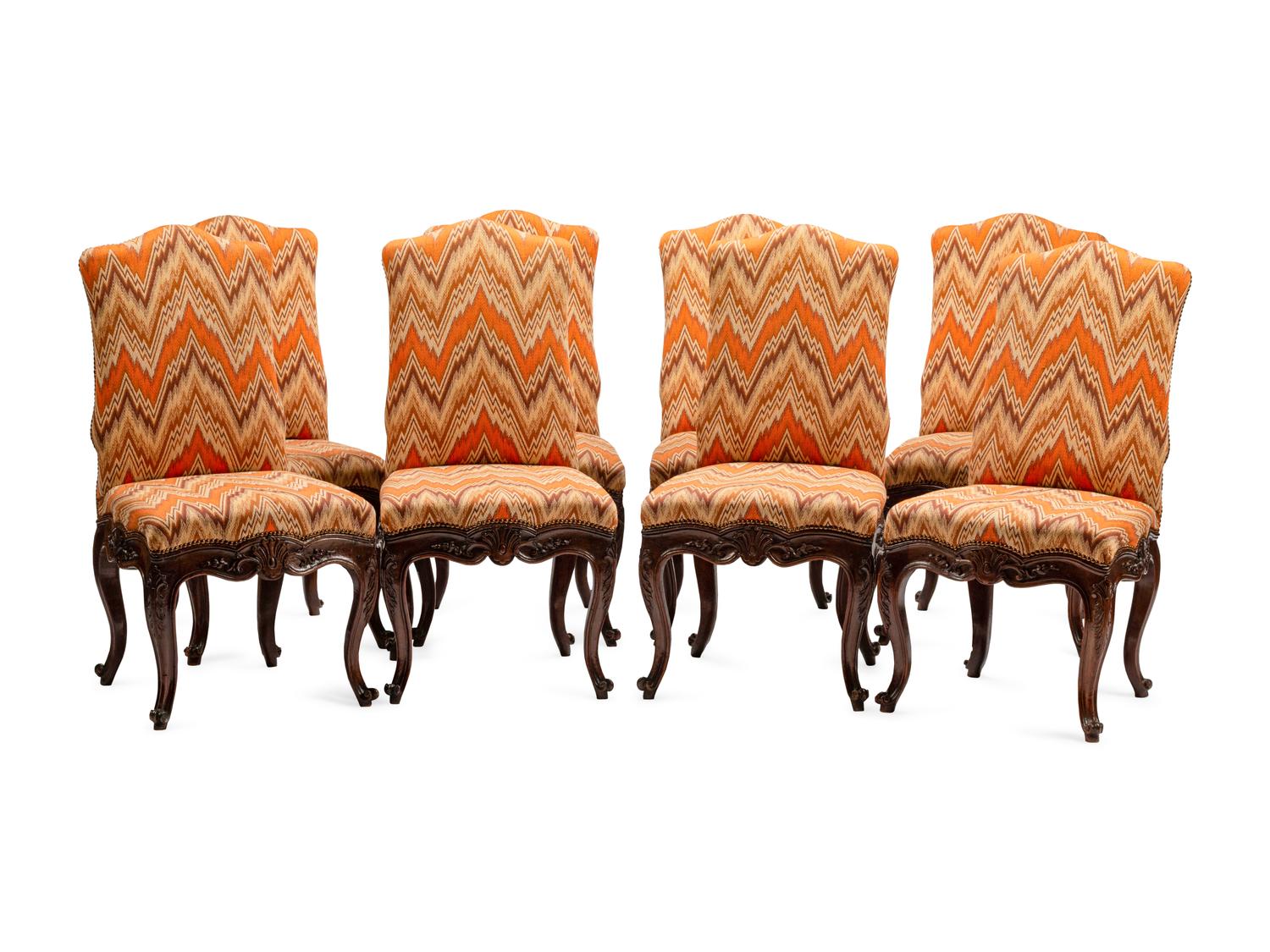 A Set of Eight Continental Carved Walnut Dining Chairs