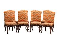 A Set of Eight Continental Carved Walnut Dining Chairs