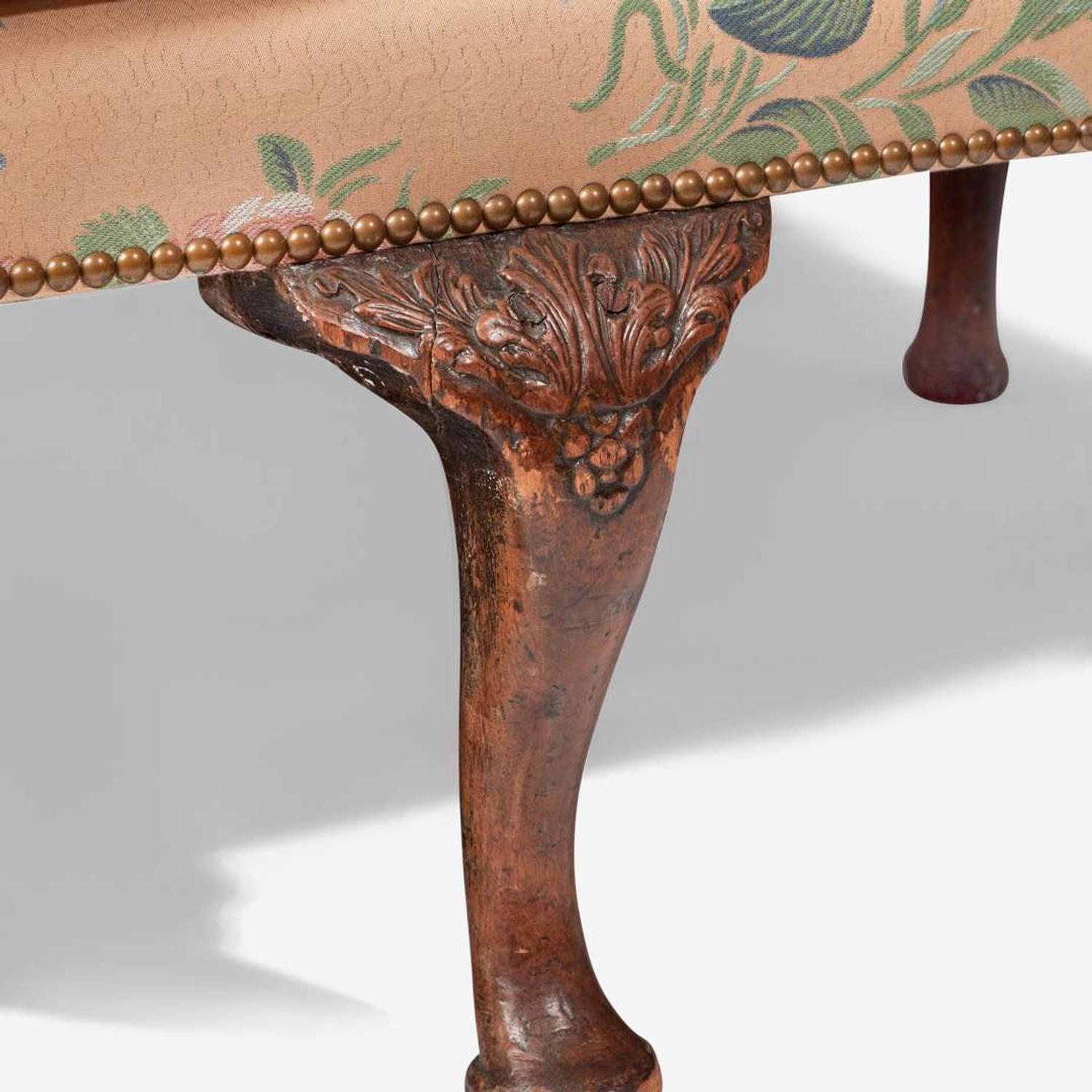 A George I carved walnut settee early 18th century