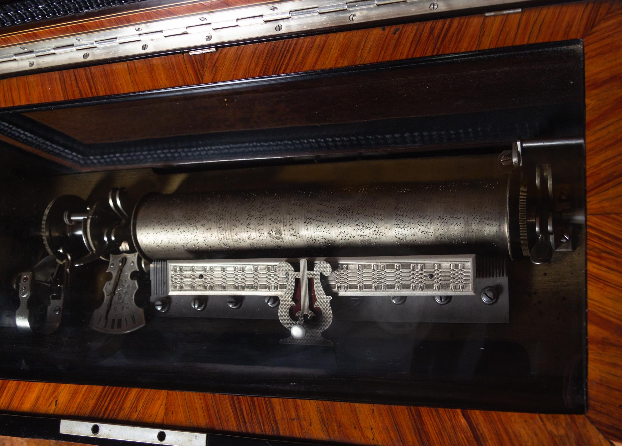 A Swiss Parcel Ebonized and Mother-of-Pearl Inlaid Burlwood Music Box on Stand