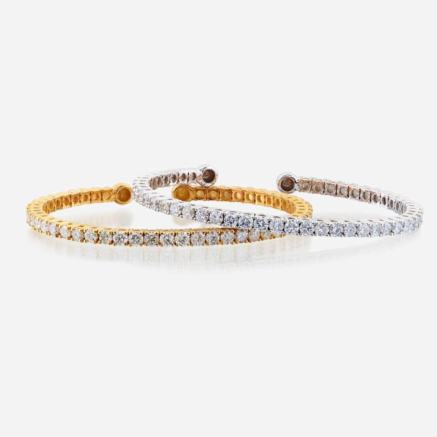 A pair of diamond and fourteen karat gold bangles