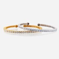 A pair of diamond and fourteen karat gold bangles