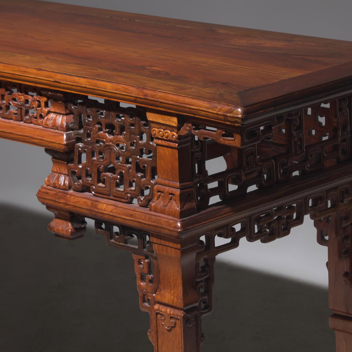 A Chinese Carved Huanghuali Side Table, Tiaozhuo, Late 19th to 20th Century 晚清民國 黃花梨透雕夔龍紋條桌