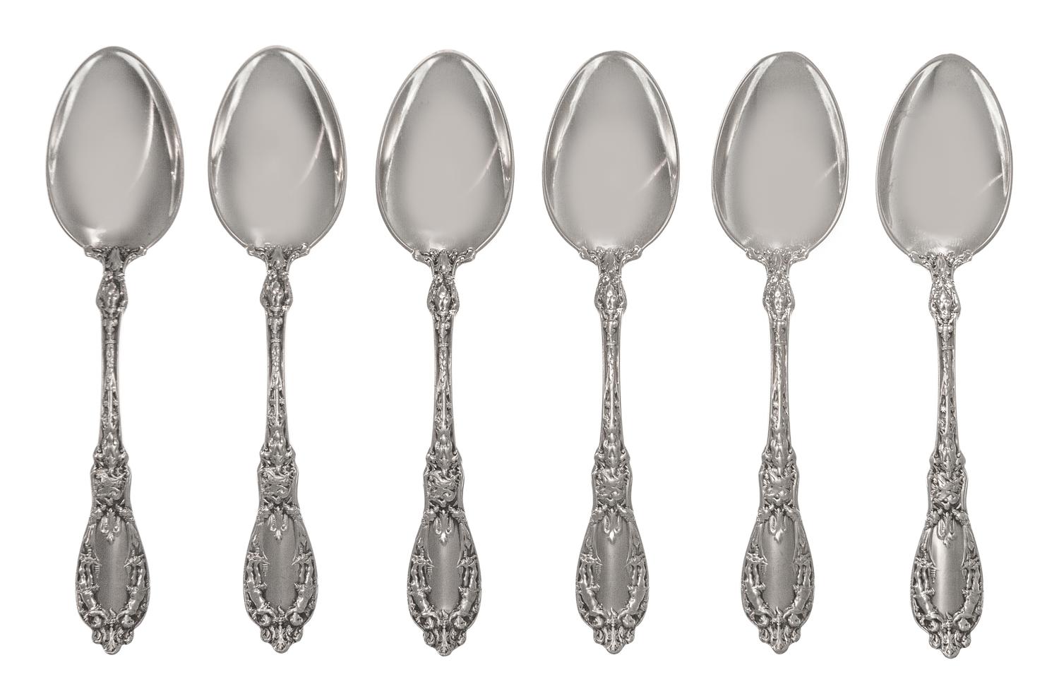 A Set of Twelve American Silver Tablespoons, Maker's Mark M in a Lozenge, each handle decorated with two putti, monogrammed LDG on the