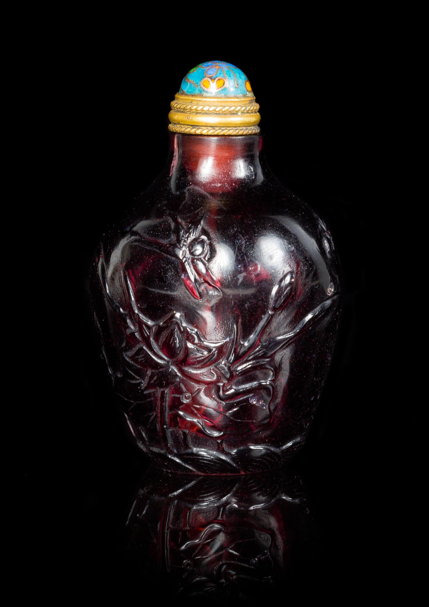 An Amethyst Tone Glass Snuff Bottle Height 2 1/2 inches.