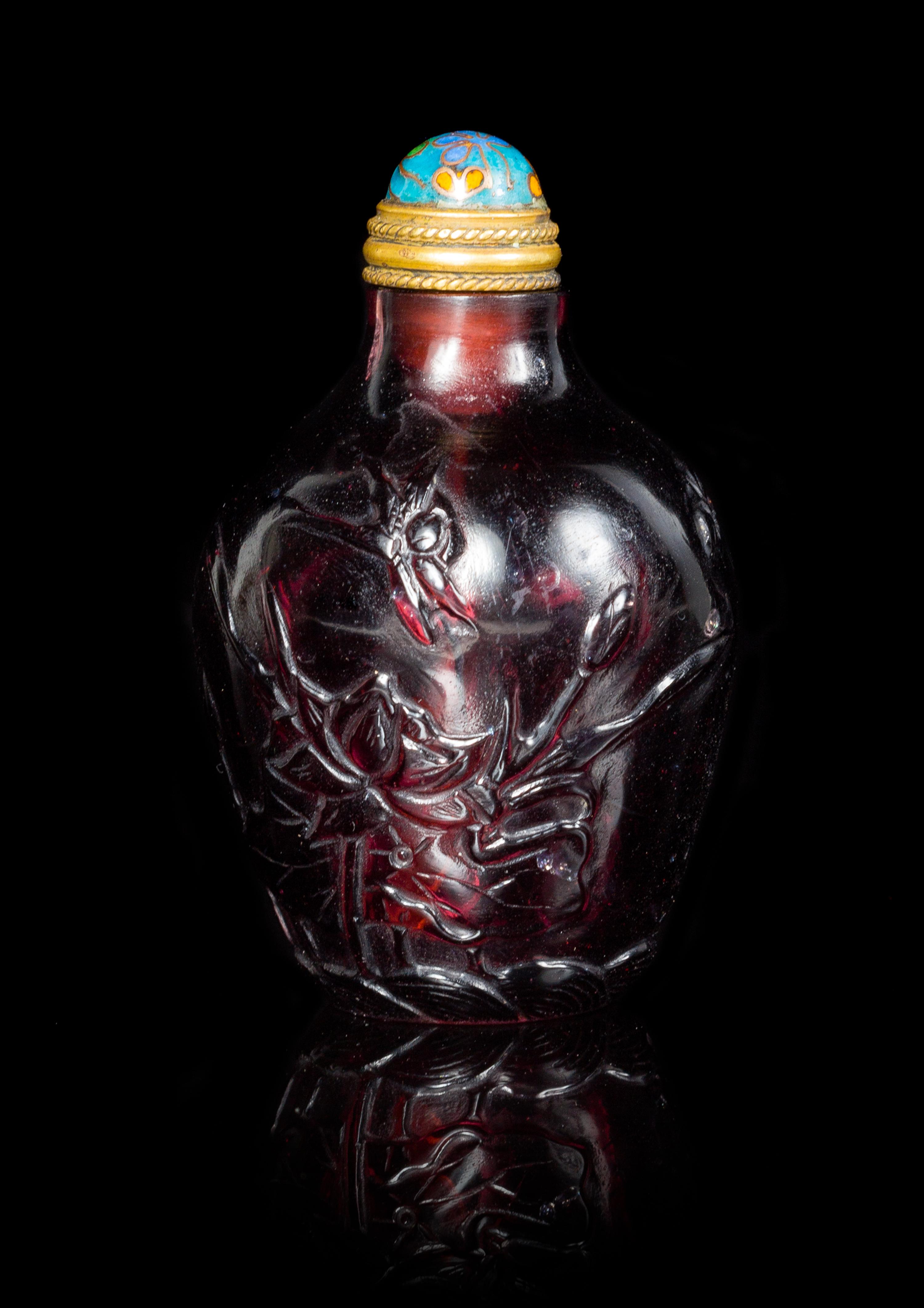 An Amethyst Tone Glass Snuff Bottle Height 2 1/2 inches.