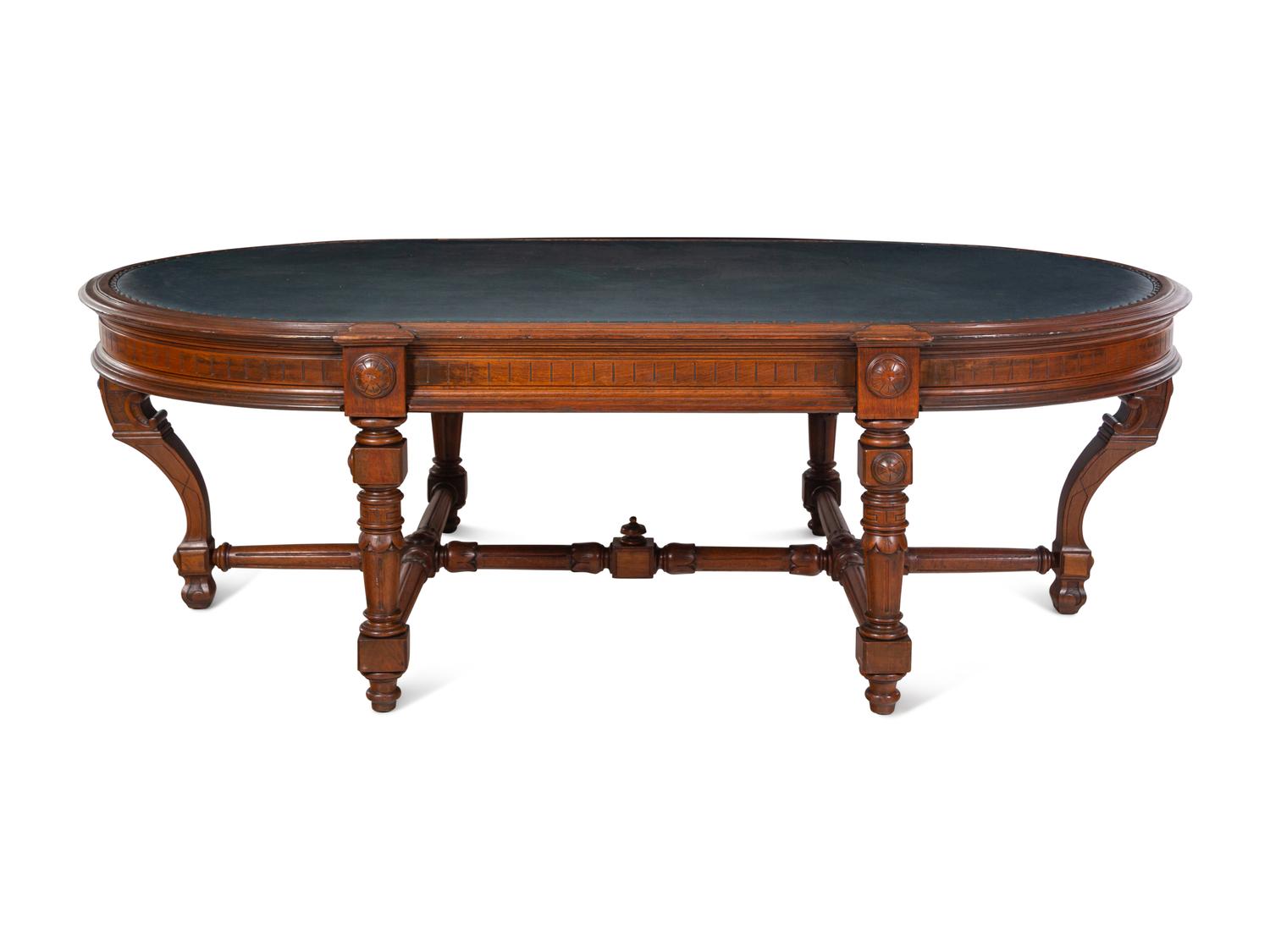 An Aesthetic Movement Leather Inset Carved Walnut Board Table