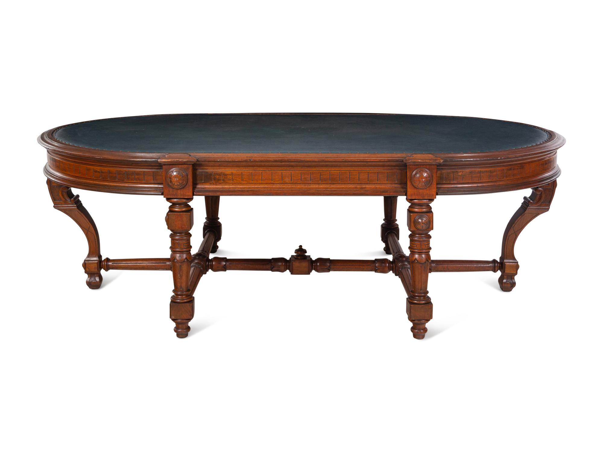 An Aesthetic Movement Leather Inset Carved Walnut Board Table