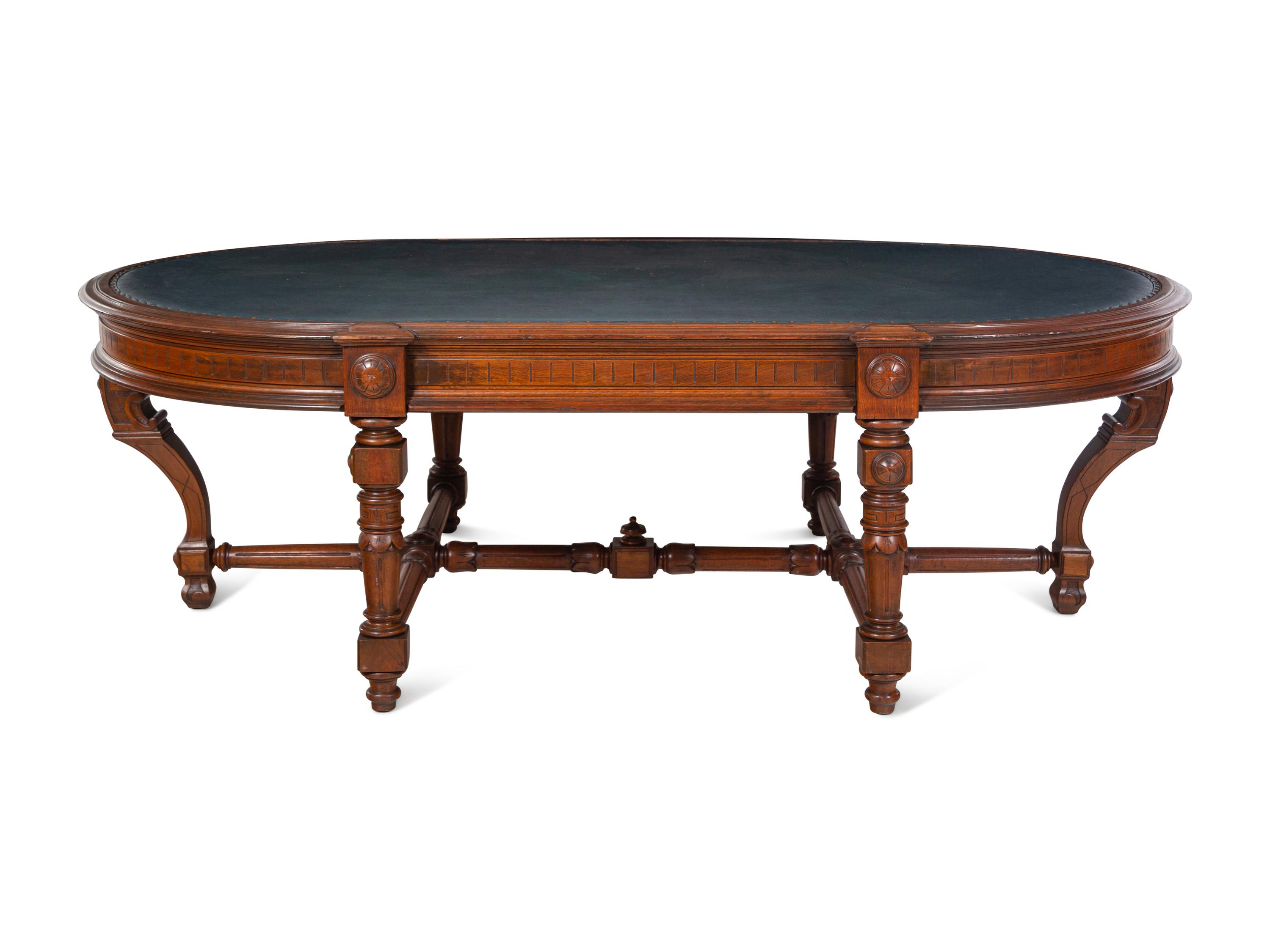 An Aesthetic Movement Leather Inset Carved Walnut Board Table