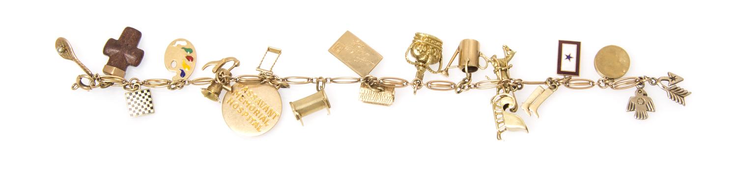 A 14 Karat Yellow Gold Bracelet with Assorted Gold and Gold Filled Charms, 17.40 dwts.