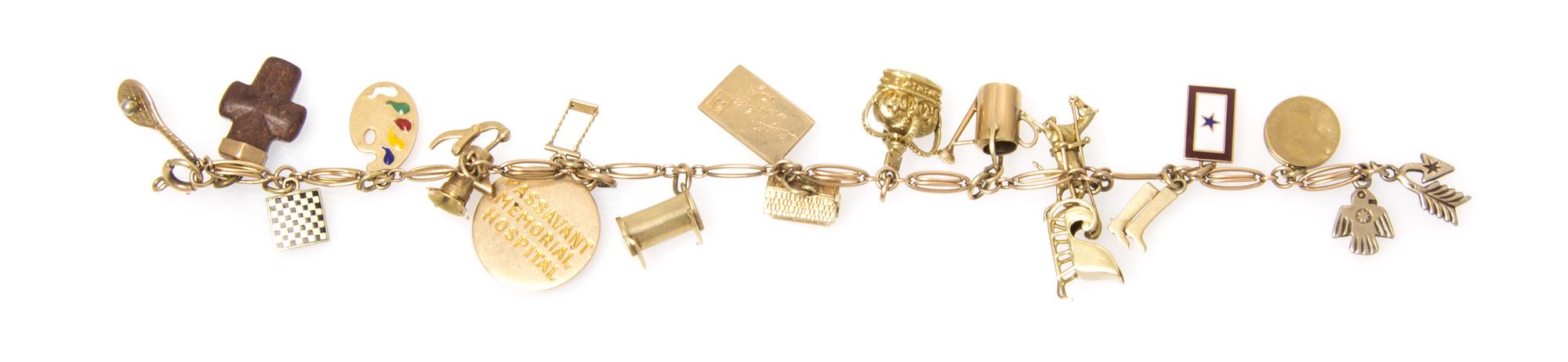 A 14 Karat Yellow Gold Bracelet with Assorted Gold and Gold Filled Charms, 17.40 dwts.