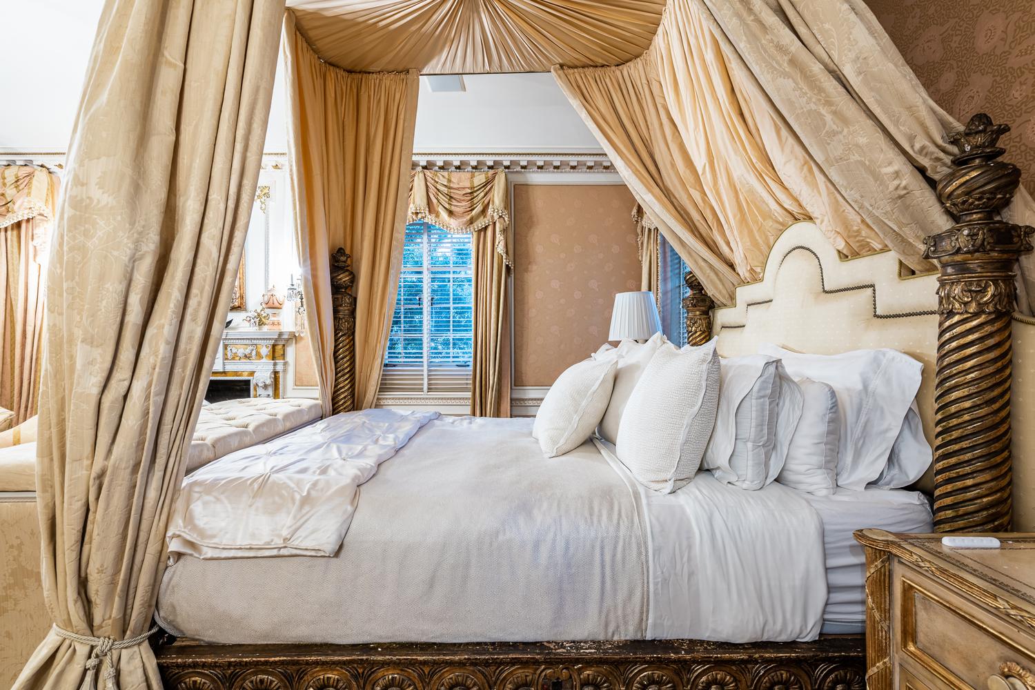 An Italian Carved Giltwood Bedstead with Baldachin, Headboard and Drapes