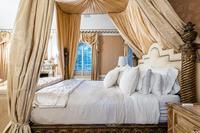 An Italian Carved Giltwood Bedstead with Baldachin, Headboard and Drapes