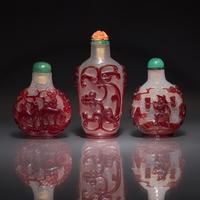 Three Chinese Ruby-Overlay Glass Snuff Bottles, 18th-19th Century — 清中期 雪霏地套寶石紅料鼻烟壺三支