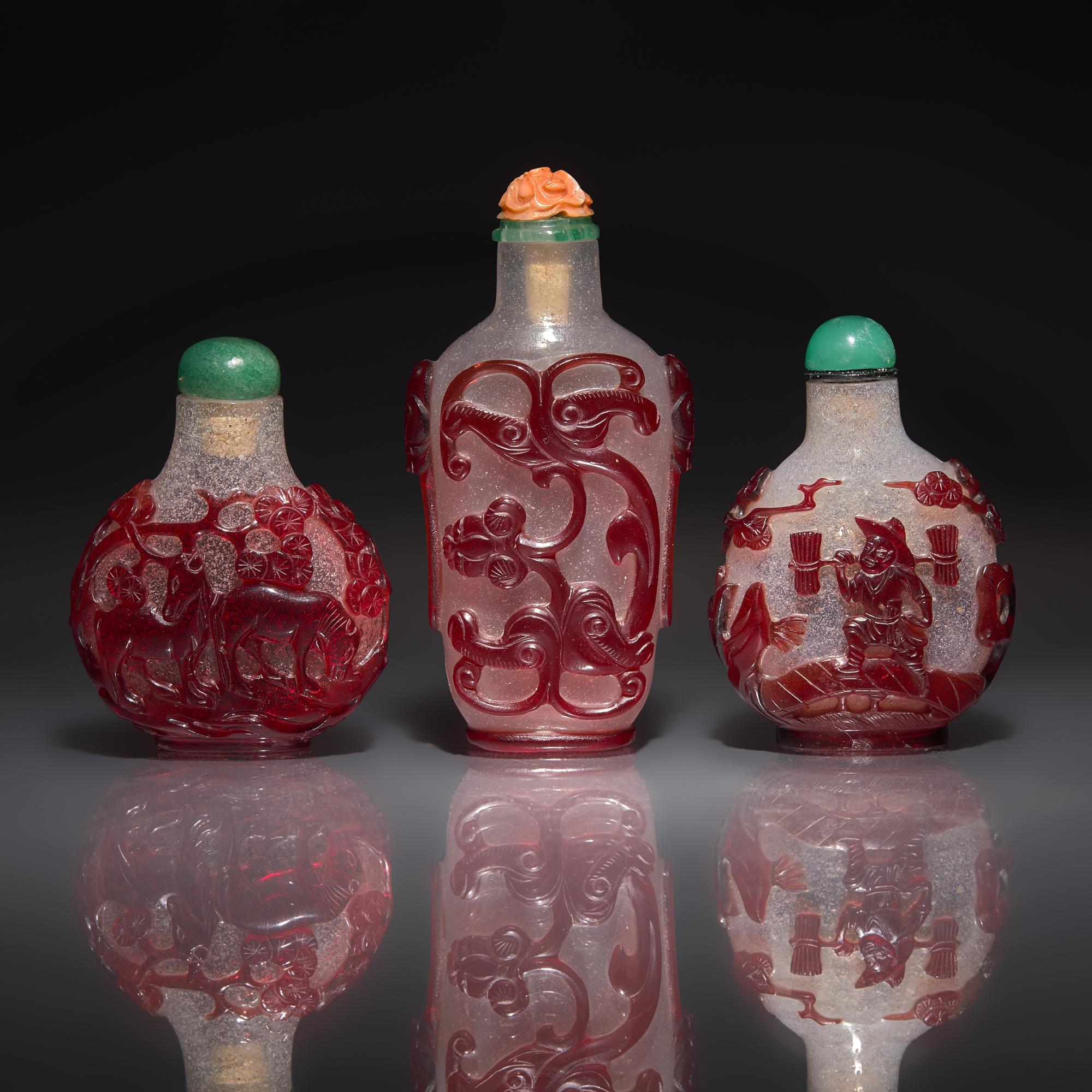 Three Chinese Ruby-Overlay Glass Snuff Bottles, 18th-19th Century — 清中期 雪霏地套寶石紅料鼻烟壺三支