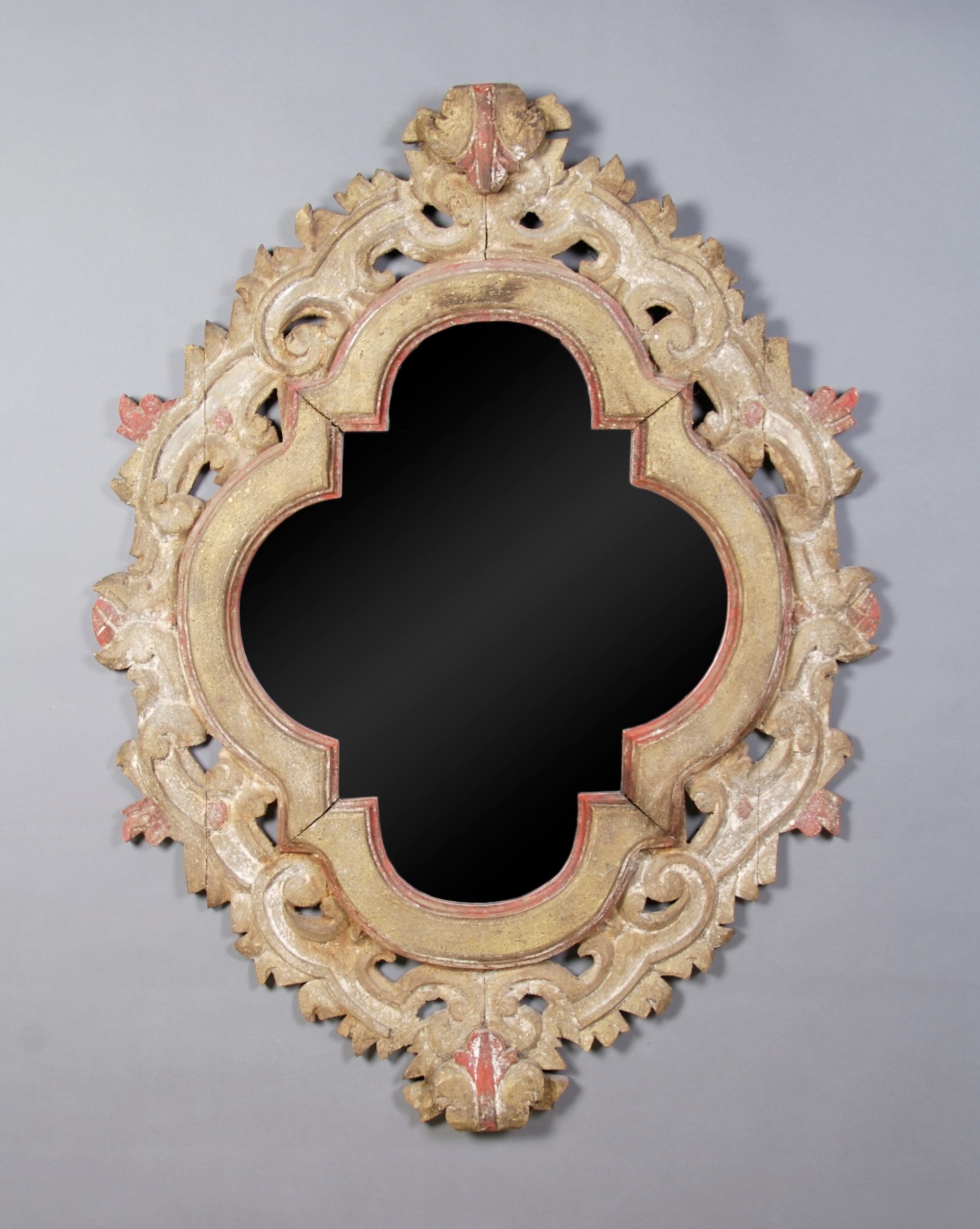 A Continental Carved Mirror, Height 44 1/2 x width 34 1/2 inches.