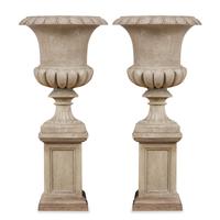 A Pair of Carved Granite Urns and Plinths