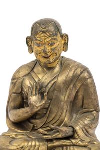 A Large Tibetan Parcel Gilt Bronze Repoussé Figure of a Seated Monk