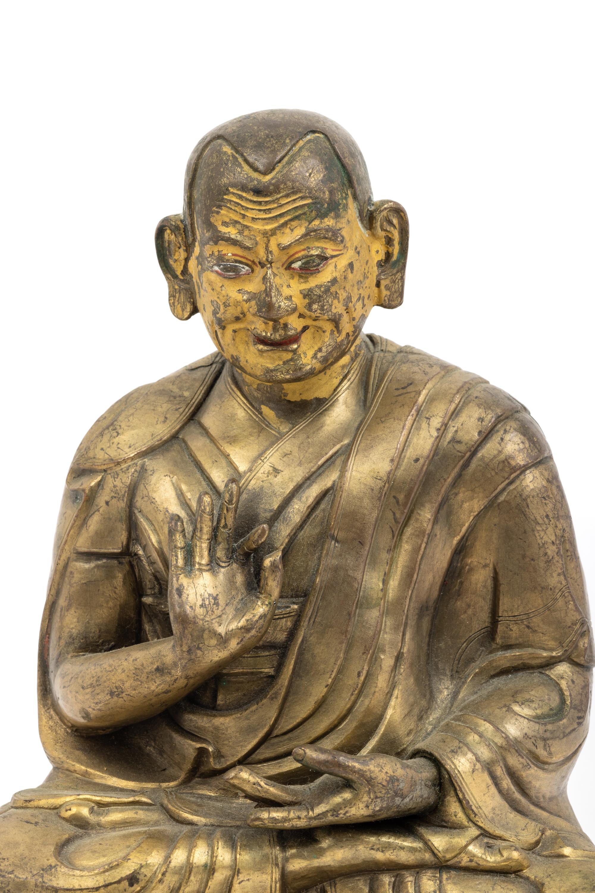 A Large Tibetan Parcel Gilt Bronze Repoussé Figure of a Seated Monk