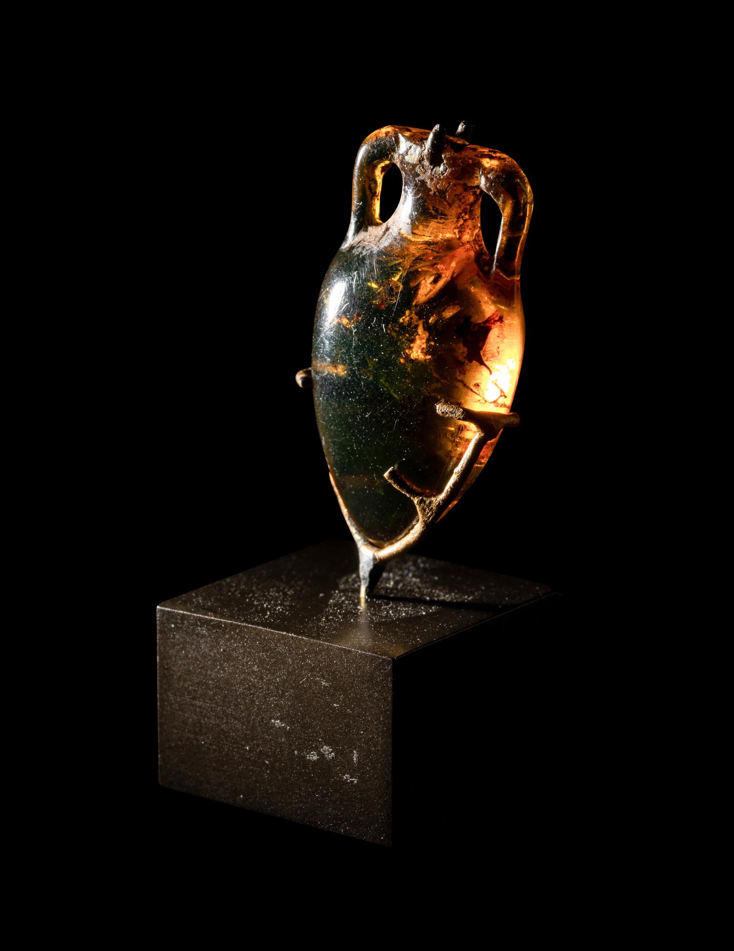 A Roman Natural Amber Amphoriskos Pendant