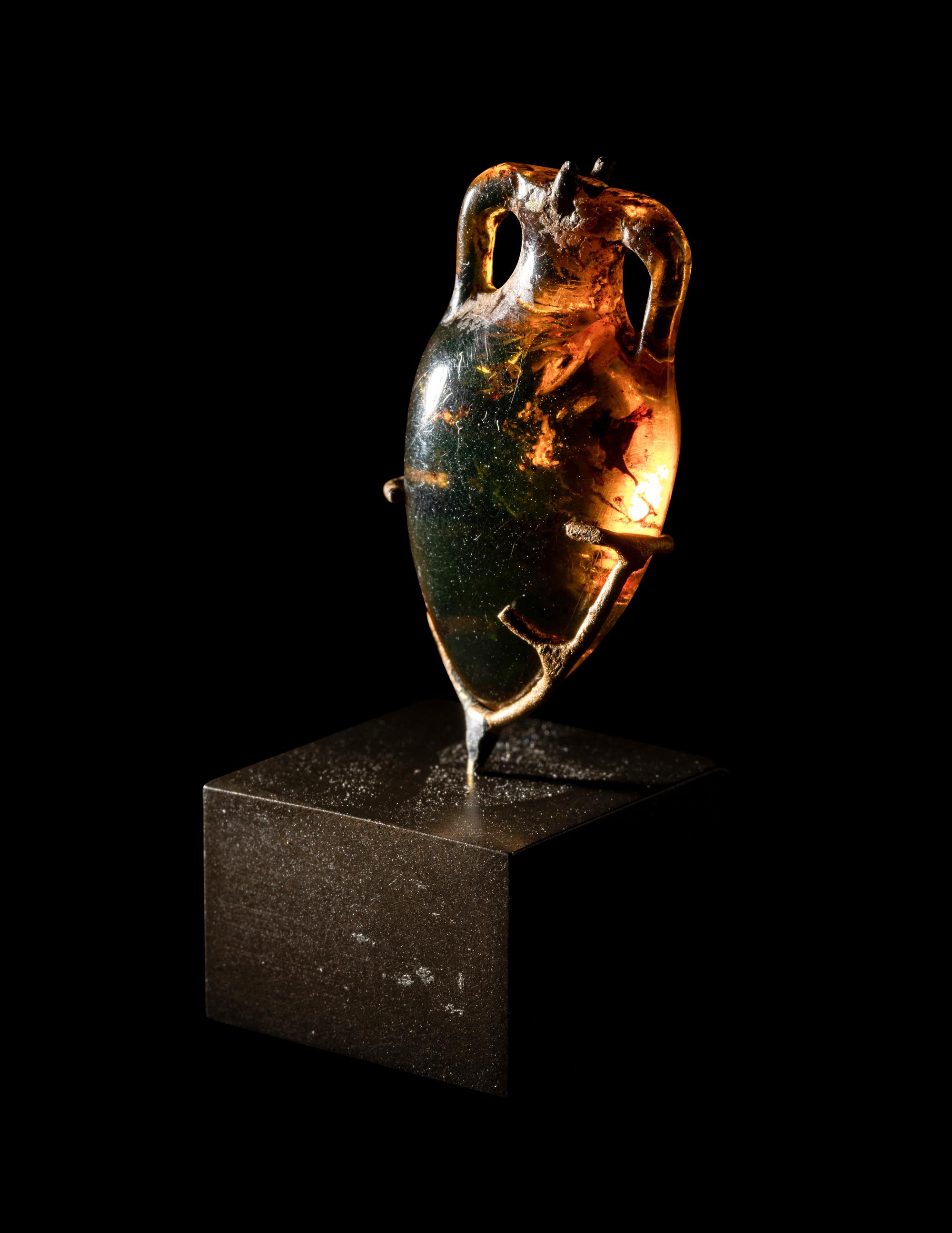 A Roman Natural Amber Amphoriskos Pendant
