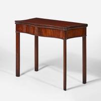 A George III serpentine carved mahogany card table circa 1770