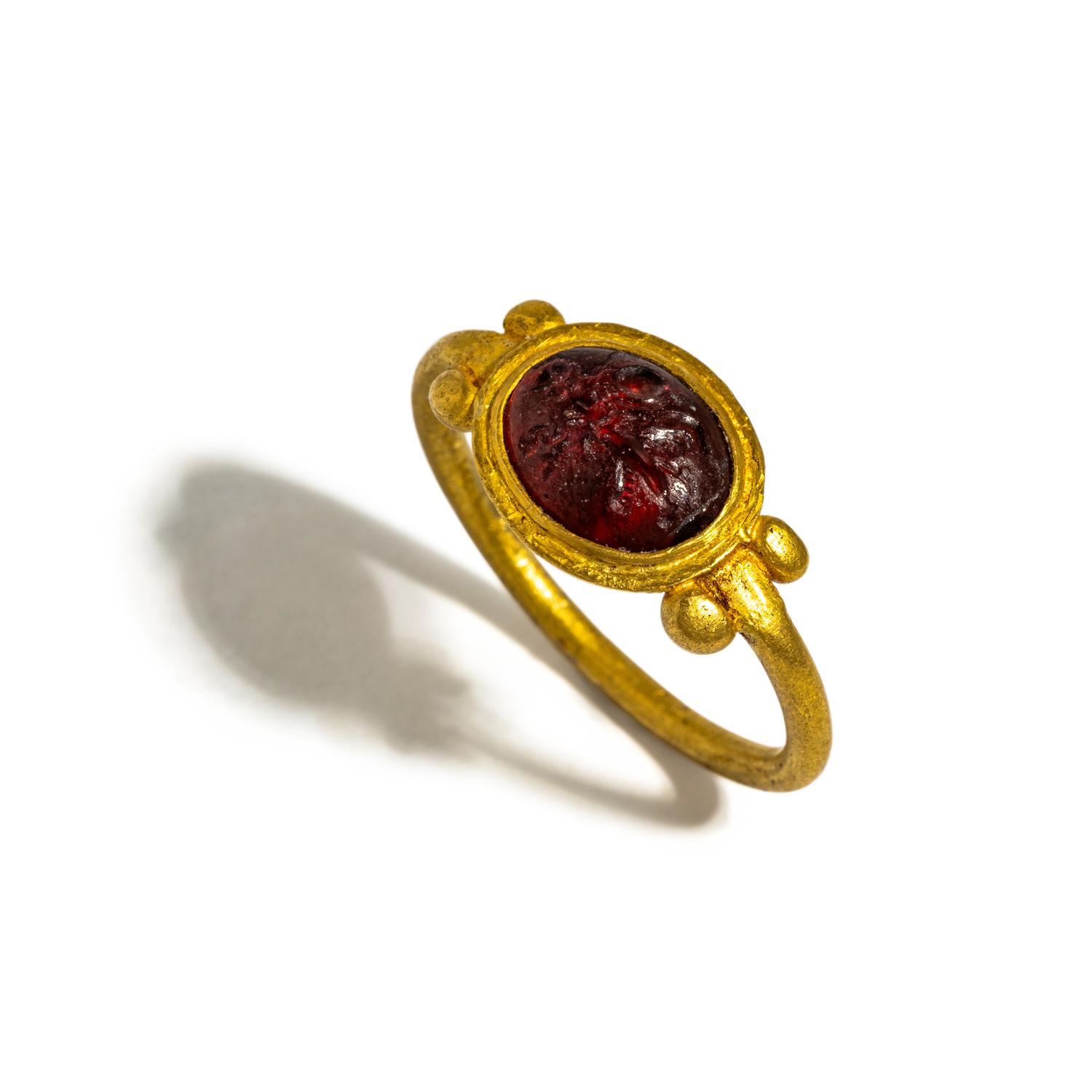 A Roman Gold and Garnet Finger Ring with the Goddess Minerva