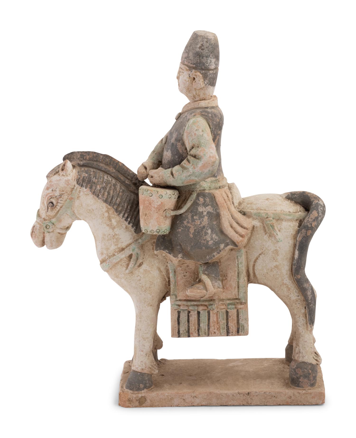 A Chinese Painted Terra Cotta Burial Figure of a Mounted Attendant