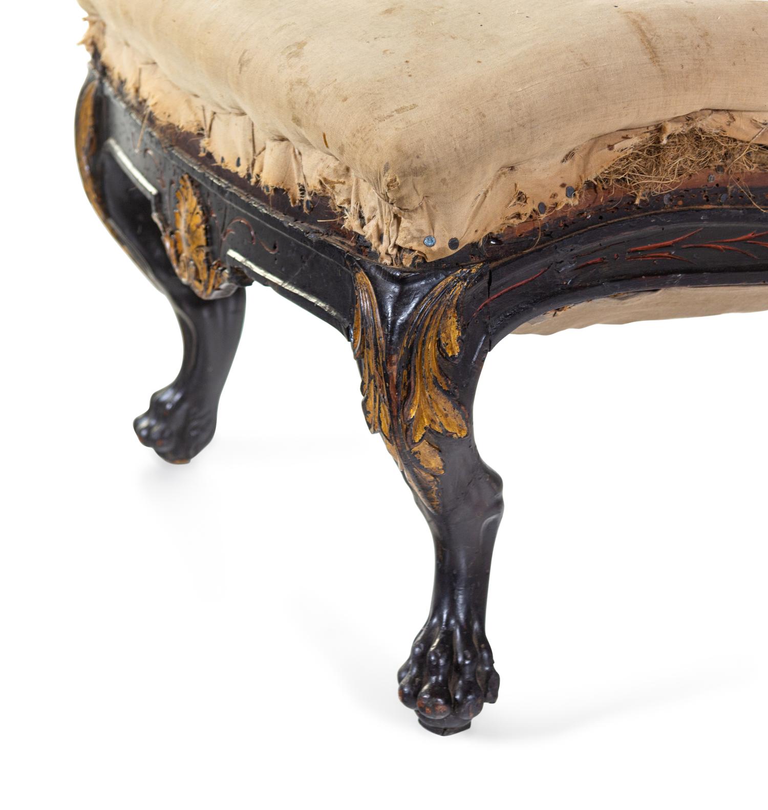 A Pair of Anglo-Colonial Carved and Parcel Gilt Slipper Chairs