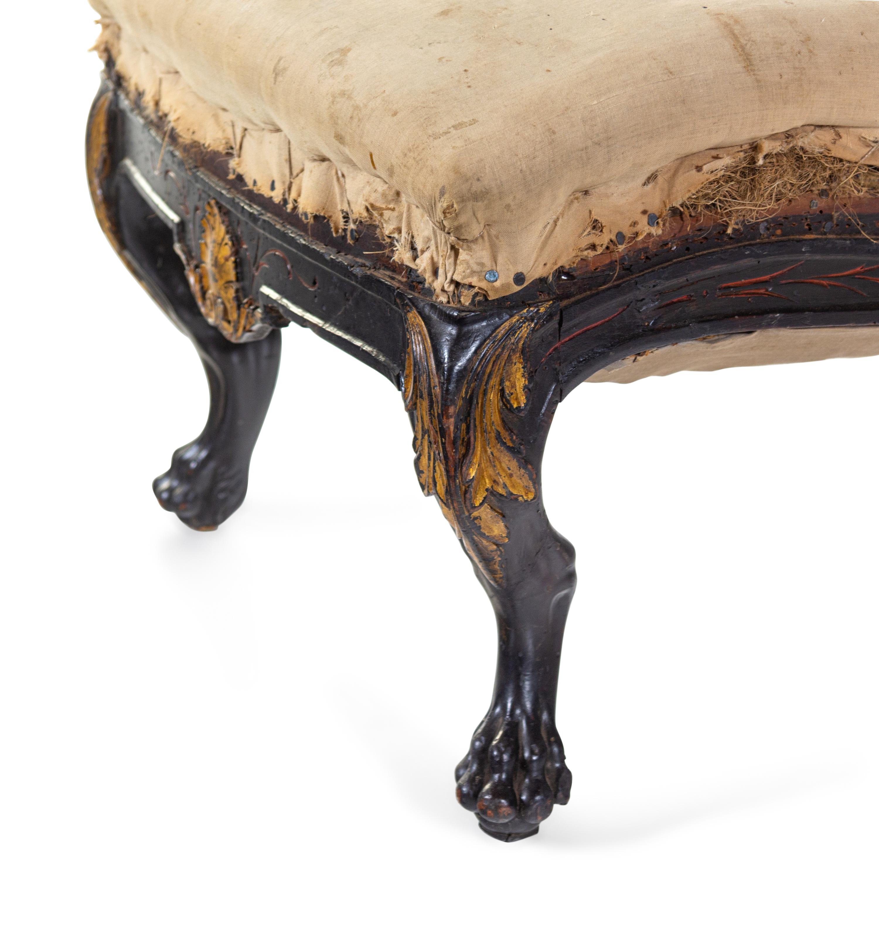 A Pair of Anglo-Colonial Carved and Parcel Gilt Slipper Chairs