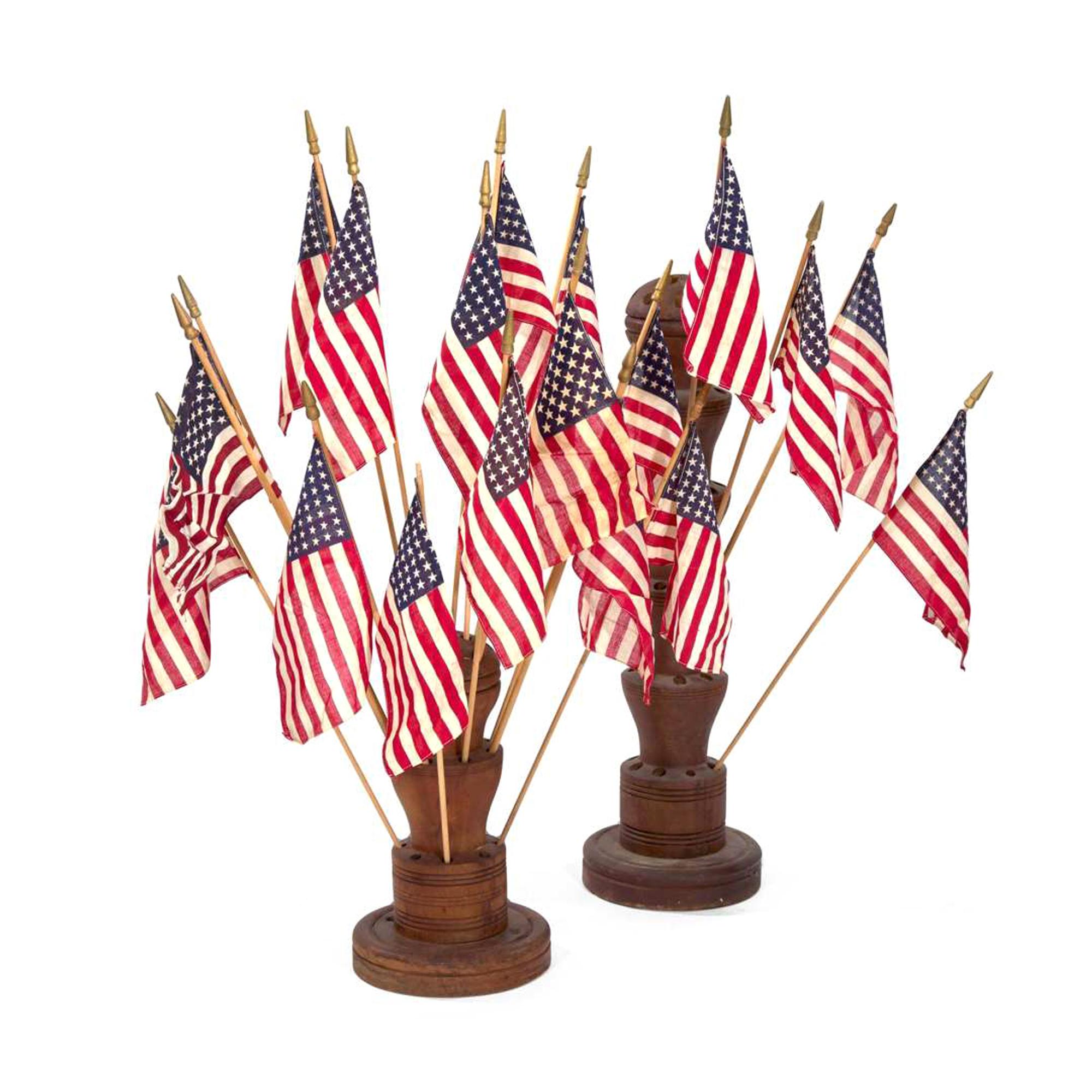 [FLAGS]. Two turned wooden flag holders. Late 19th-early 20th century.