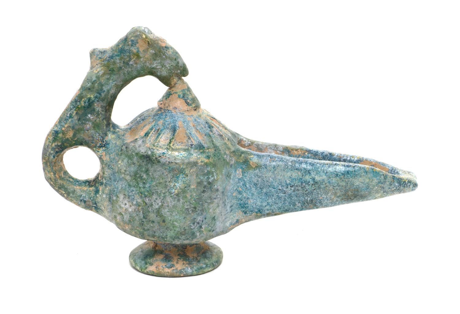 A Middle Eastern Glazed Earthenware Oil Lamp, Height 5 1/2 inches.